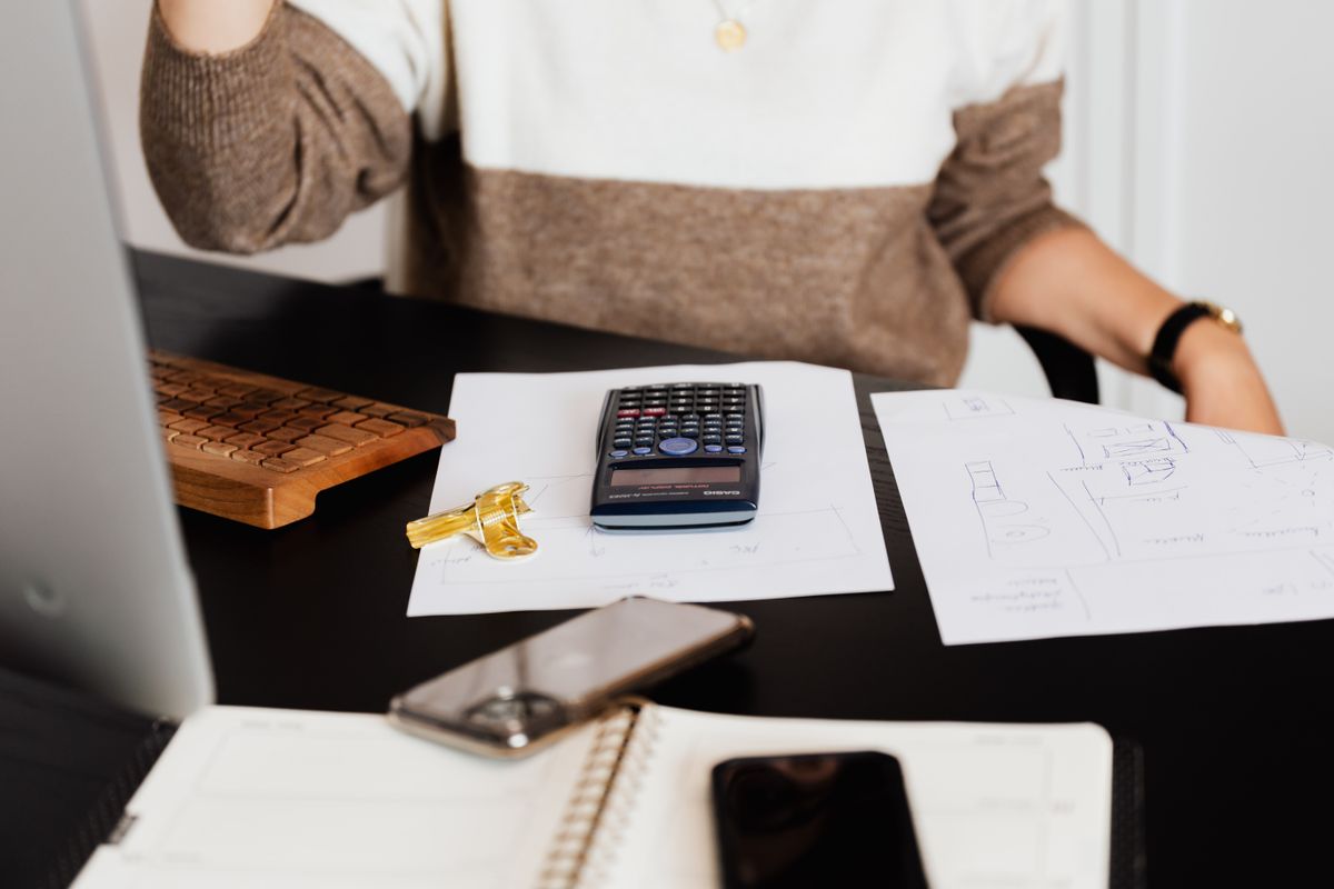 Calculator, papers and a notebook on a desk