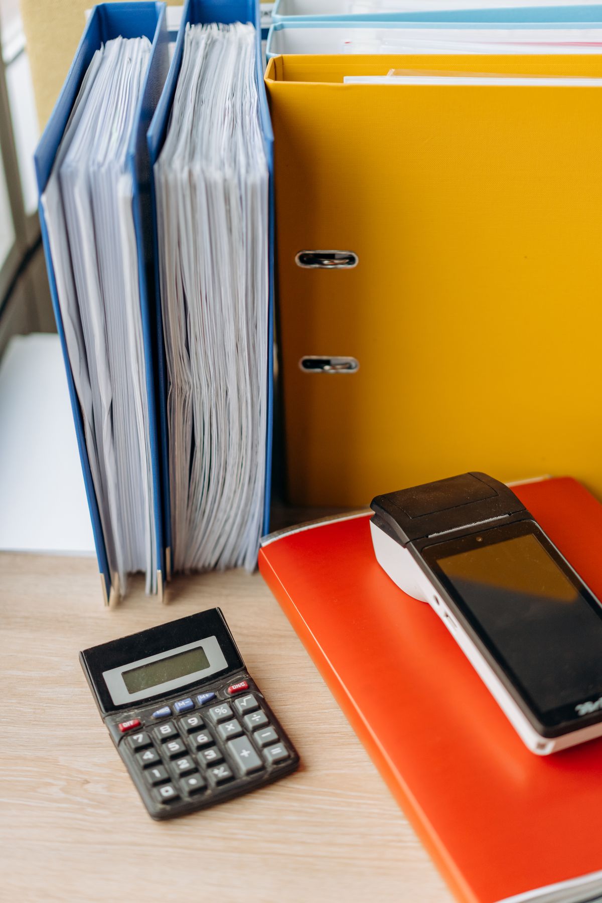 Folders of documents beside a calculator